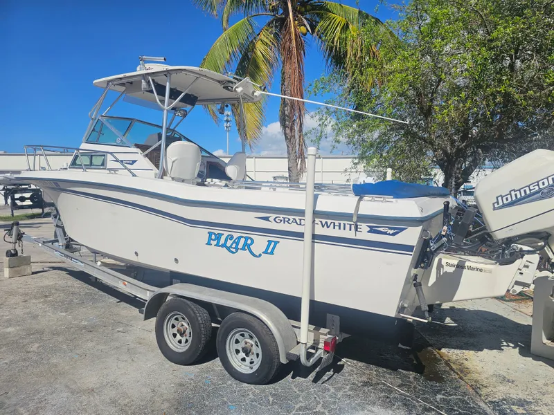 Slide: The Image of 1985 Grady-White 228 Seafarer boat on trailer, parked under palm tree. - 3