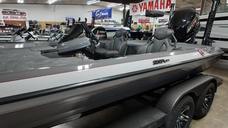 Slide: The Image of 2025 Skeeter ZXR 21 boat in showroom, featuring sleek design and Yamaha engine. - 2