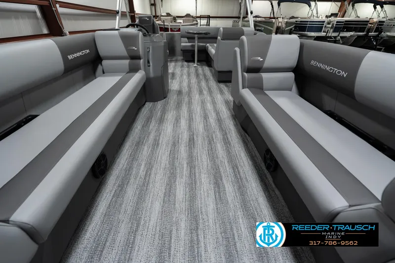 Slide: The Image of 2025 Bennington 22 SLSE pontoon boat interior with gray seating and carpet flooring. - 13