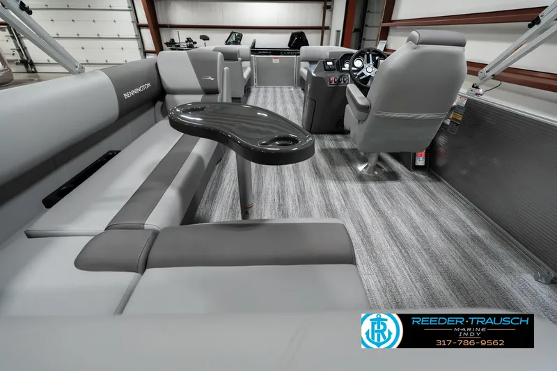 Slide: The Image of 2025 Bennington 22 SLSE pontoon boat interior with gray seating and modern dashboard. - 16