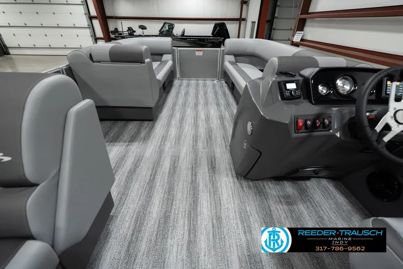 Slide: The Image of 2025 Bennington 22 SLSE pontoon boat interior with gray seating and modern dashboard. - 17