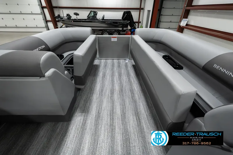 Slide: The Image of 2025 Bennington 22 SLSE pontoon boat interior with gray seating and carpet flooring. - 19