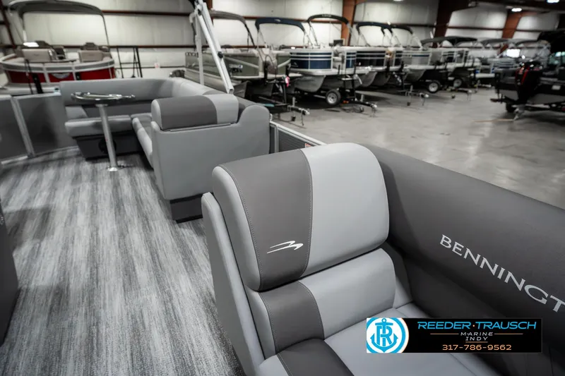 Slide: The Image of 2025 Bennington 22 SLSE pontoon boat interior with gray seating in showroom. - 20