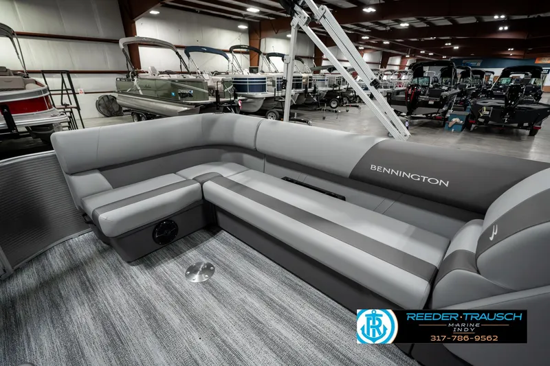 Slide: The Image of 2025 Bennington 22 SLSE pontoon boat interior with gray seating in showroom. - 23
