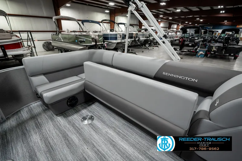 Slide: The Image of 2025 Bennington 22 SLSE pontoon boat interior with gray seating in showroom. - 24