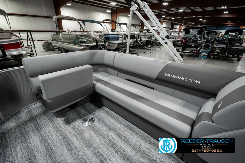 Slide: The Image of 2025 Bennington 22 SLSE pontoon boat interior with gray seating in showroom. - 25