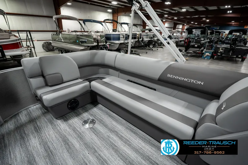 Slide: The Image of 2025 Bennington 22 SLSE pontoon boat interior with gray seating in showroom. - 26