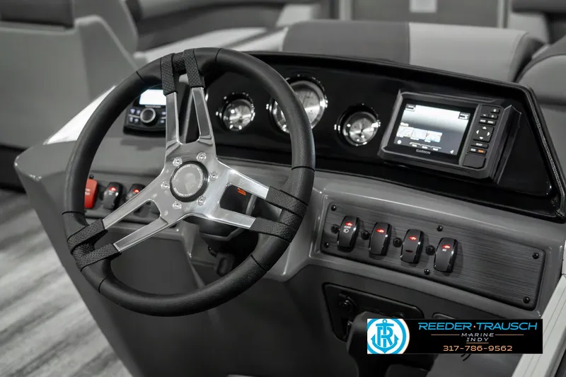 Slide: The Image of 2025 Bennington 22 SLSE boat dashboard with steering wheel and control panel. - 27