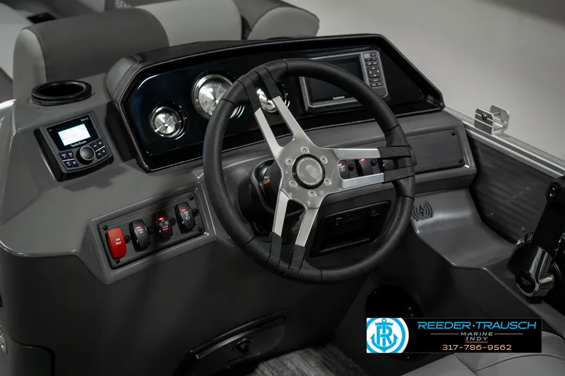 Slide: The Image of 2025 Bennington 22 SLSE boat dashboard with steering wheel and control panel. - 28