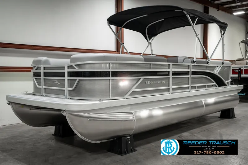 Slide: The Image of 2025 Bennington 22 SLSE pontoon boat with canopy in showroom. - 3