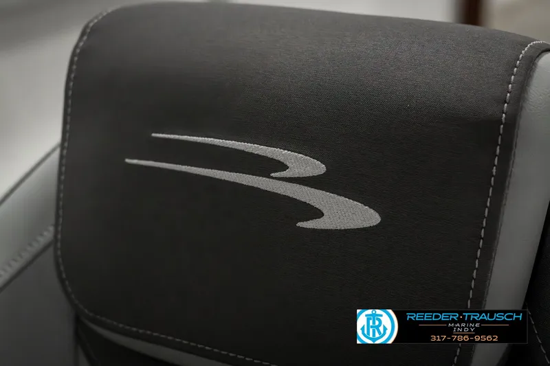 Slide: The Image of Bennington 22 SLSE 2025 boat seat with logo, featuring sleek black upholstery. - 42