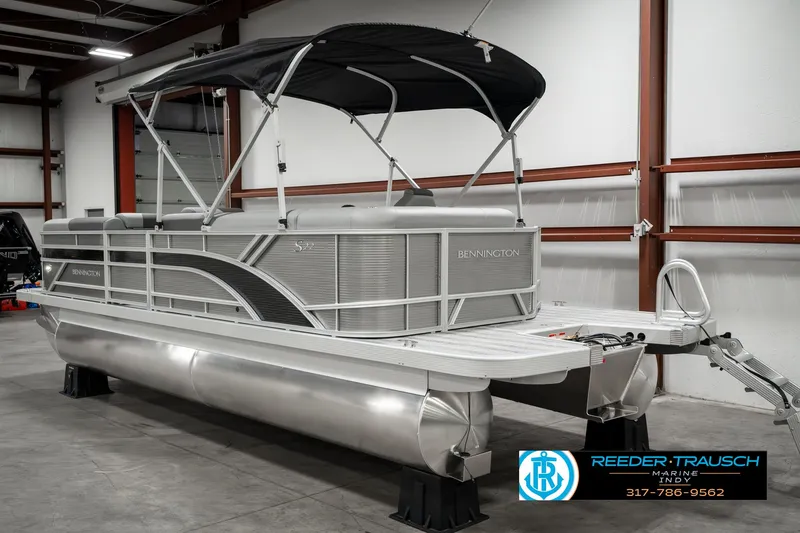Slide: The Image of 2025 Bennington 22 SLSE pontoon boat in a showroom with canopy and sleek design. - 7