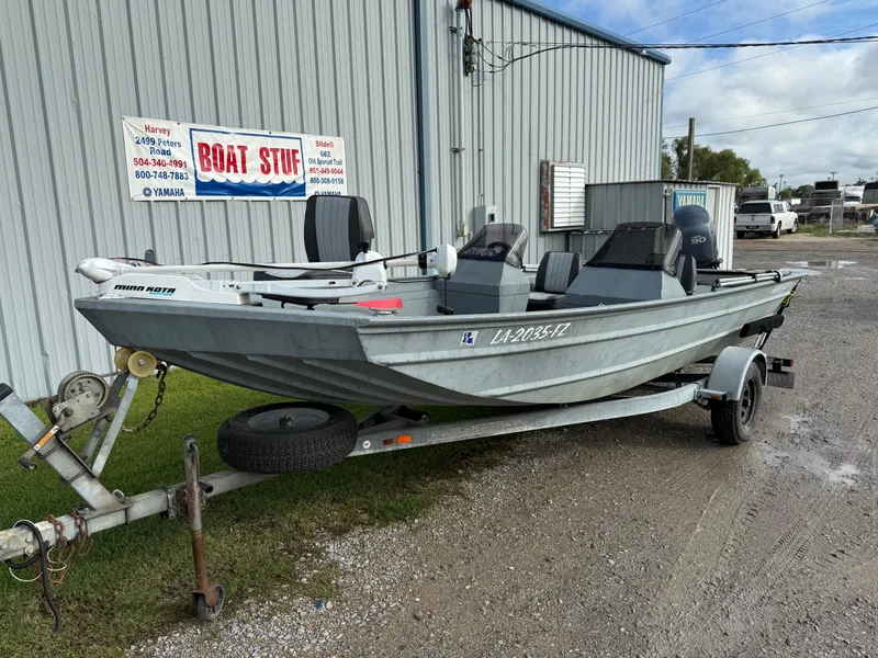 Slide: The Image of 2012 Alweld 1960VVSC Bay boat on trailer, parked outside a metal building. - 6