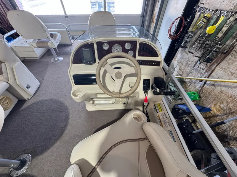 Slide: The Image of 2006 Godfrey Sweetwater 2186 DF boat interior with steering wheel and control panel. - 10