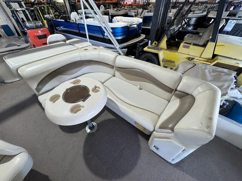Slide: The Image of 2006 Godfrey Sweetwater 2186 DF boat seating with table in storage facility. - 11