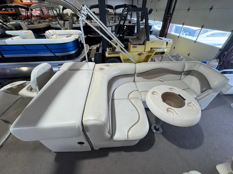 Slide: The Image of 2006 Godfrey Sweetwater 2186 DF pontoon boat interior with beige seating and table. - 12