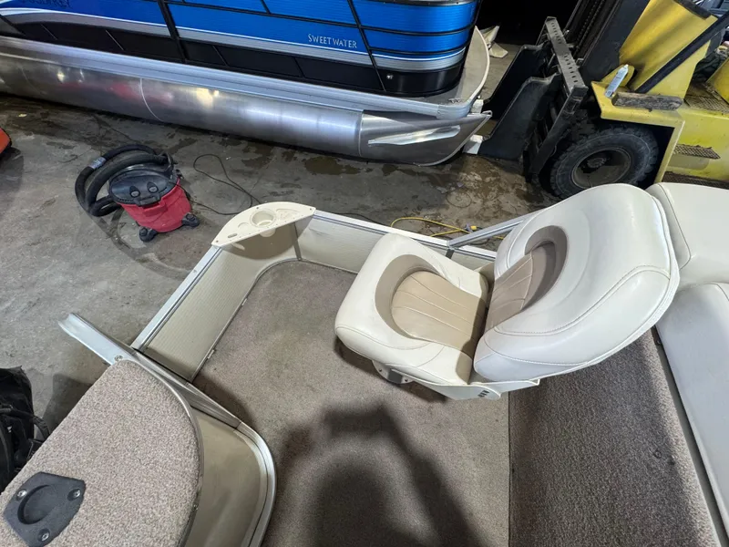 Slide: The Image of 2006 Godfrey Sweetwater 2186 DF boat interior with beige seating and carpeted floor. - 15