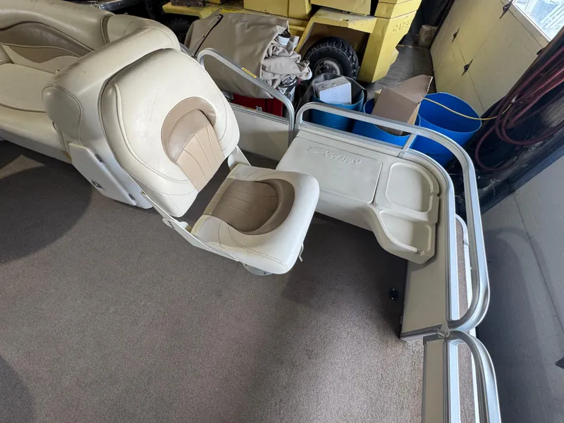 Slide: The Image of 2006 Godfrey Sweetwater 2186 DF boat interior with beige seating and storage area. - 4