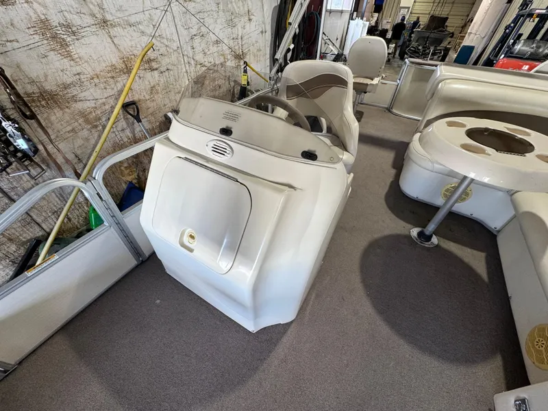 Slide: The Image of 2006 Godfrey Sweetwater 2186 DF boat interior with steering console and seating area. - 7