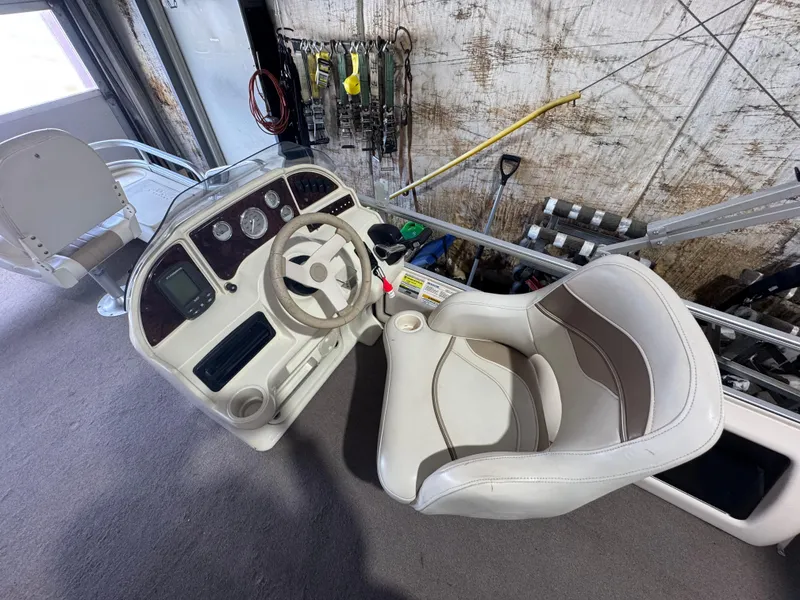 Slide: The Image of 2006 Godfrey Sweetwater 2186 DF boat interior with steering wheel and captain's chair. - 9