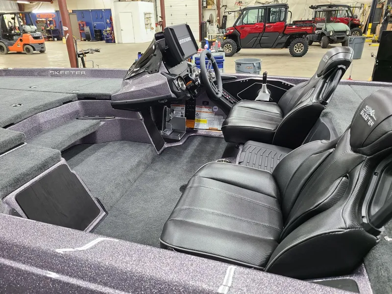 Slide: The Image of 2024 Skeeter ZXR 20 boat interior with black leather seats and modern dashboard. - 5