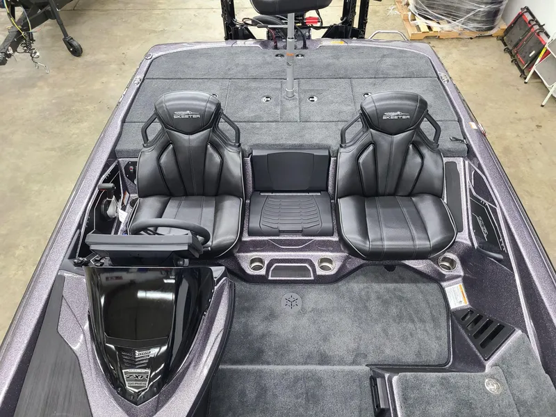 Slide: The Image of 2024 Skeeter ZXR 20 boat interior with dual black seats and modern dashboard. - 9