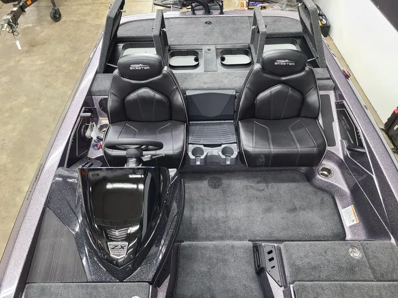 Slide: The Image of 2024 Skeeter ZX 200 boat interior with dual black seats and steering console. - 12