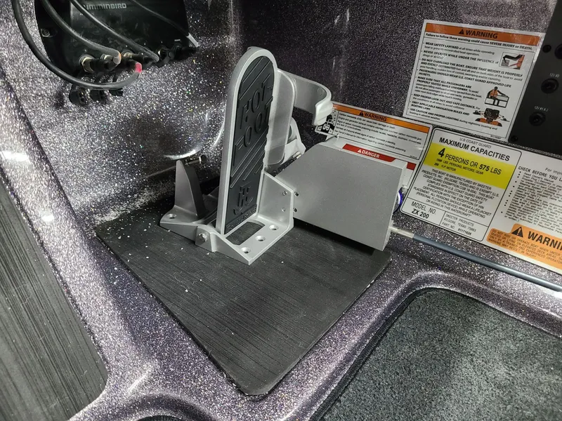 Slide: The Image of 2024 Skeeter ZX 200 boat foot pedal and warning labels. - 14