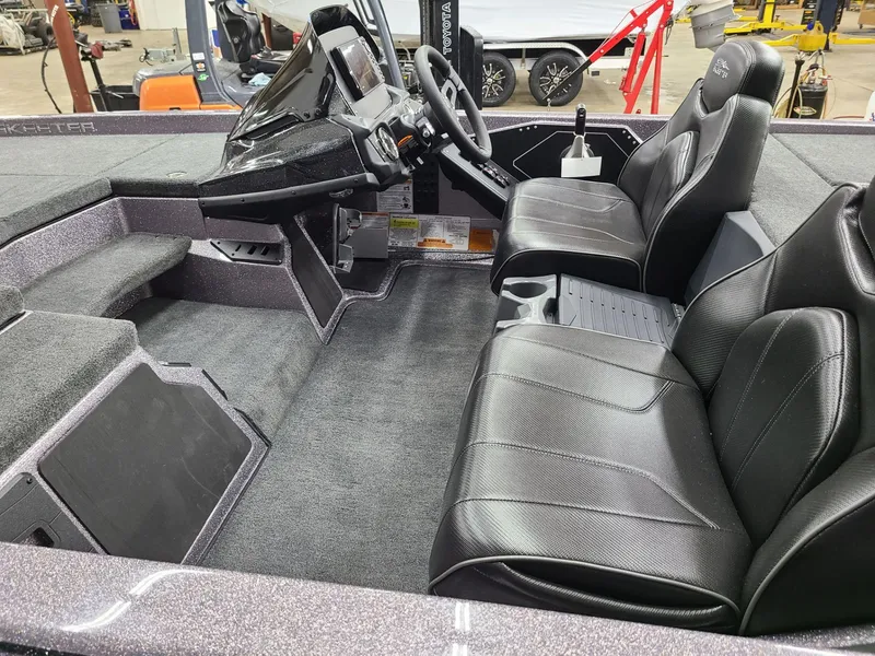 Slide: The Image of 2024 Skeeter ZX 200 boat interior with black leather seats and modern dashboard. - 8