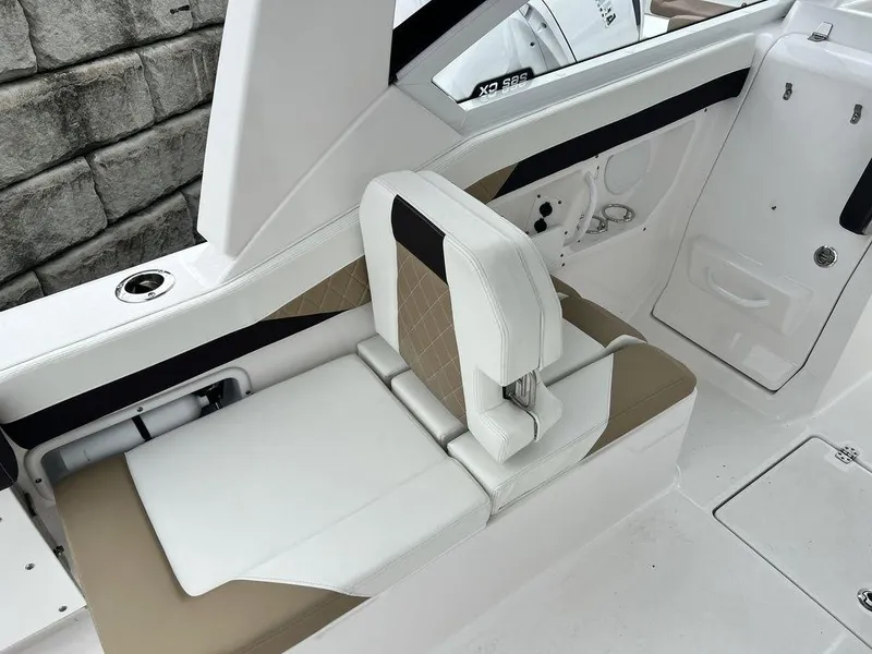 Slide: The Image of 2022 Edgewater 262CX boat interior with beige and white seating. - 10