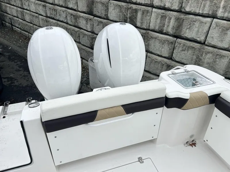 Slide: The Image of 2022 Edgewater 262CX boat with dual outboard engines and sleek seating. - 11