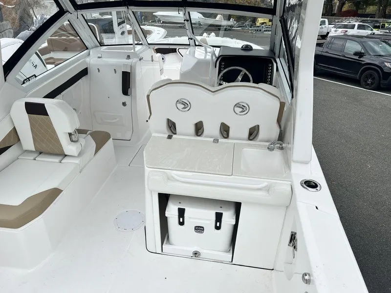 Slide: The Image of 2022 Edgewater 262CX boat interior with seating and storage. - 13
