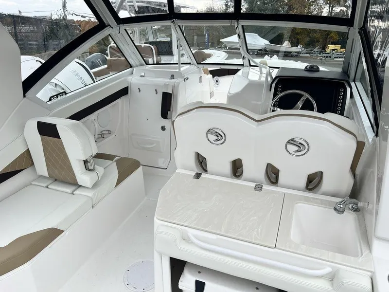 Slide: The Image of 2022 Edgewater 262CX boat interior with seating and helm, featuring modern design and amenities. - 5