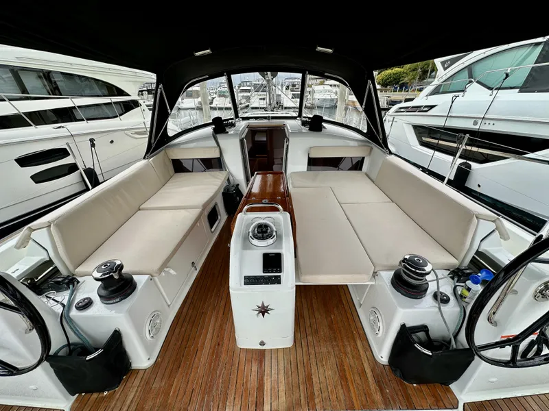 Slide: The Image of 2020 Jeanneau Sun Odyssey 490 yacht cockpit with seating and wooden flooring. - 13