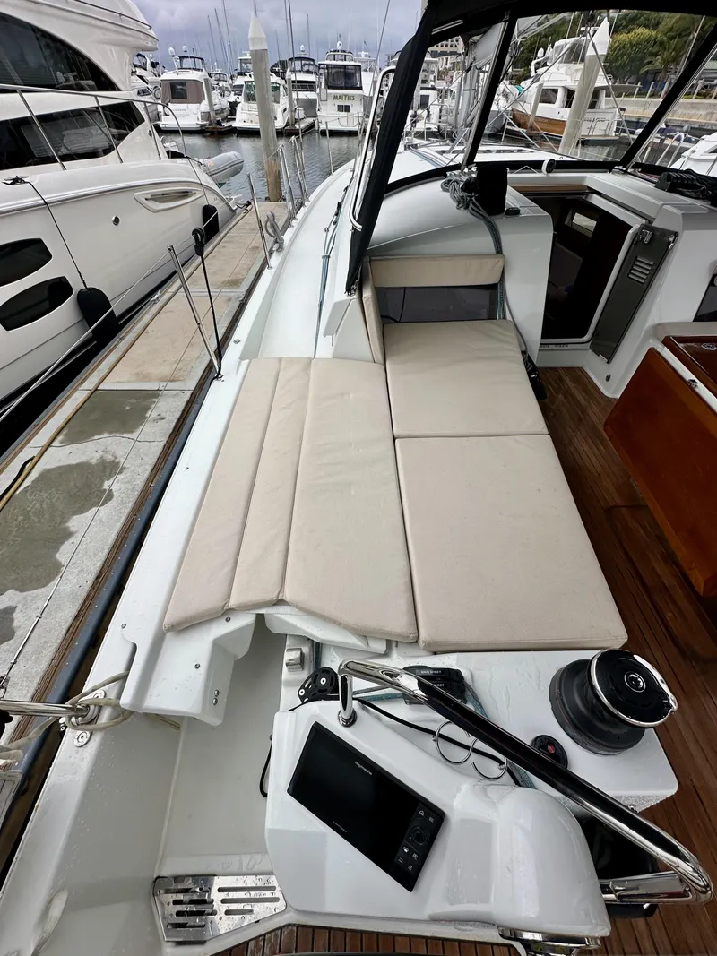 Slide: The Image of Jeanneau Sun Odyssey 490 sailboat, 2020 model, docked with spacious deck and seating area. - 16