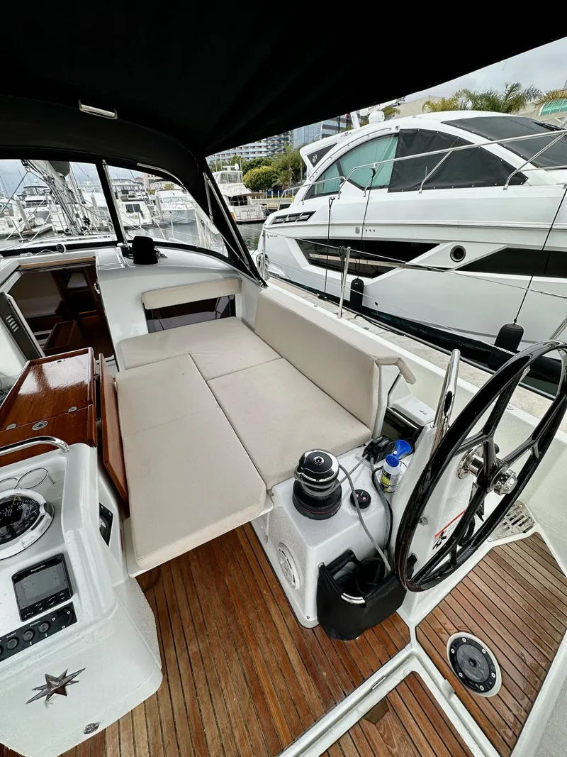 Slide: The Image of 2020 Jeanneau Sun Odyssey 490 yacht interior with steering wheel and seating area. - 17