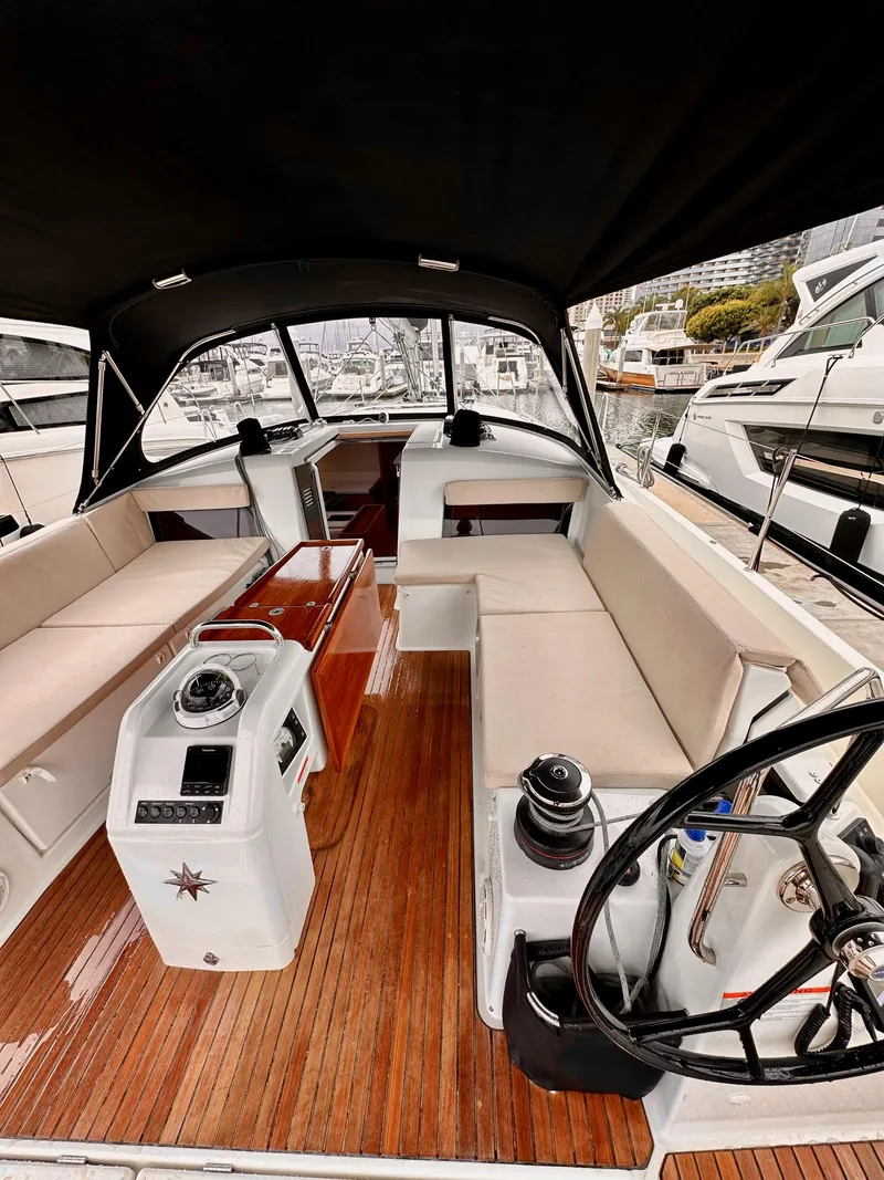 Slide: The Image of Interior of 2020 Jeanneau Sun Odyssey 490 sailboat with modern helm and seating. - 20