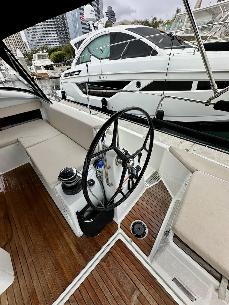 Slide: The Image of Jeanneau Sun Odyssey 490 yacht cockpit with steering wheel, 2020 model, docked at marina. - 22