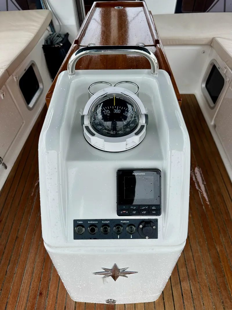 Slide: The Image of Jeanneau Sun Odyssey 490 cockpit compass and controls, 2020 model, on teak deck. - 23
