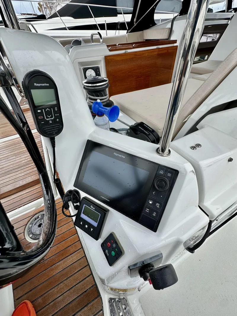 Slide: The Image of Cockpit of 2020 Jeanneau Sun Odyssey 490 with navigation equipment and controls. - 26