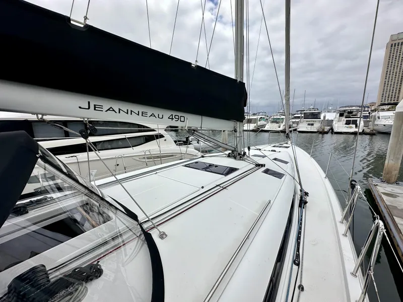 Slide: The Image of 2020 Jeanneau Sun Odyssey 490 sailboat docked in marina, overcast sky. - 29