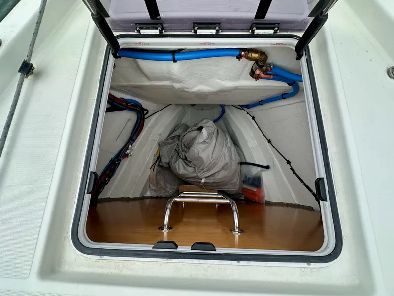 Slide: The Image of Storage compartment of 2020 Jeanneau Sun Odyssey 490 sailboat, featuring organized cables and equipment. - 35