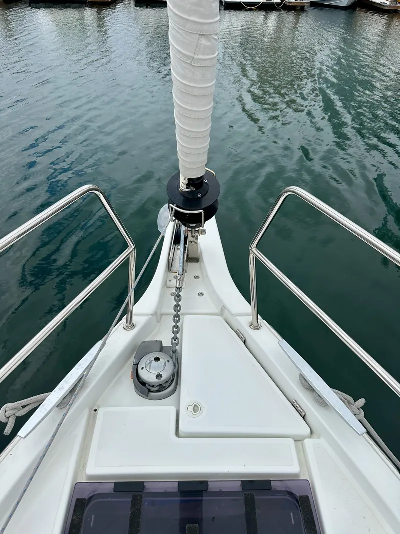 Slide: The Image of Jeanneau Sun Odyssey 490 sailboat bow, 2020 model, anchored in calm waters. - 37