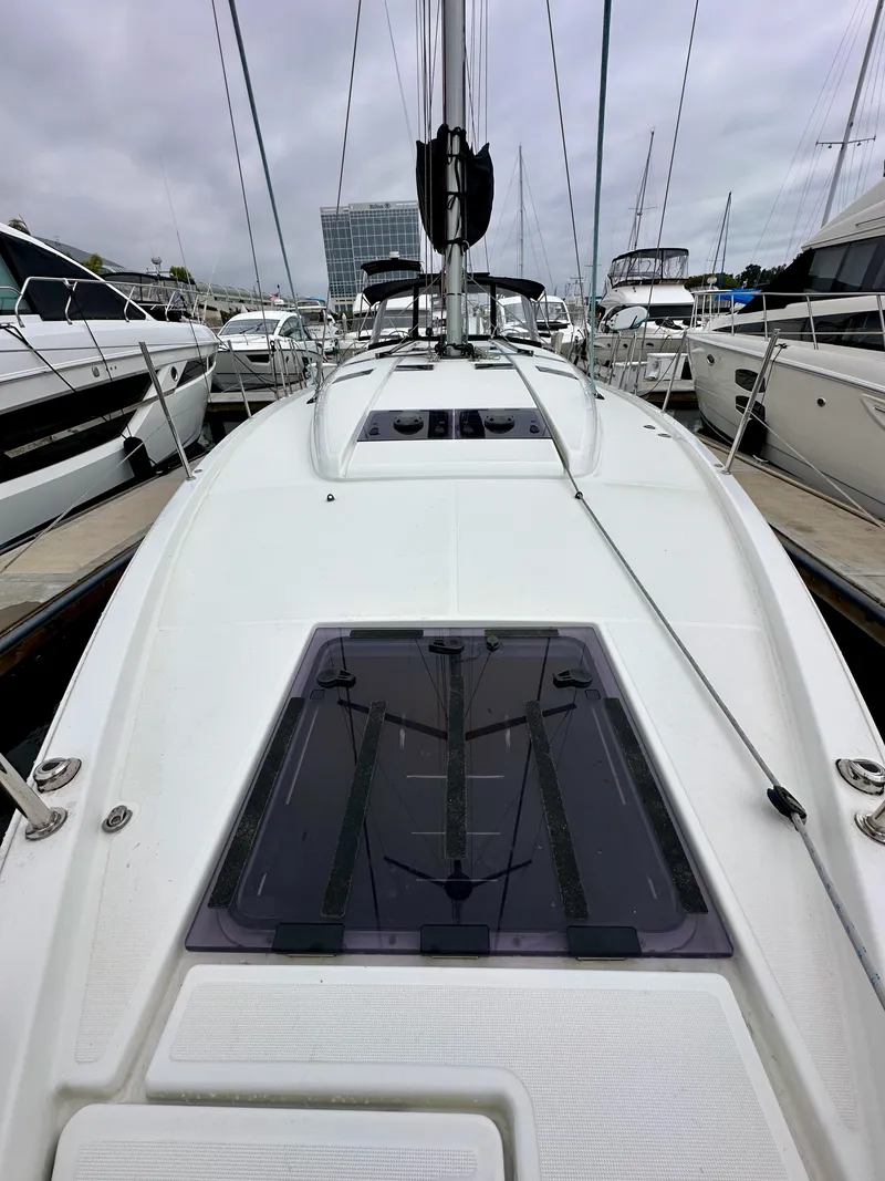 Slide: The Image of Jeanneau Sun Odyssey 490 sailboat, 2020 model, docked among other yachts. - 41