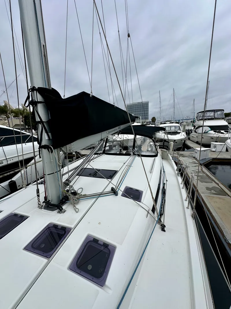 Slide: The Image of 2020 Jeanneau Sun Odyssey 490 sailboat docked in marina, overcast sky. - 43