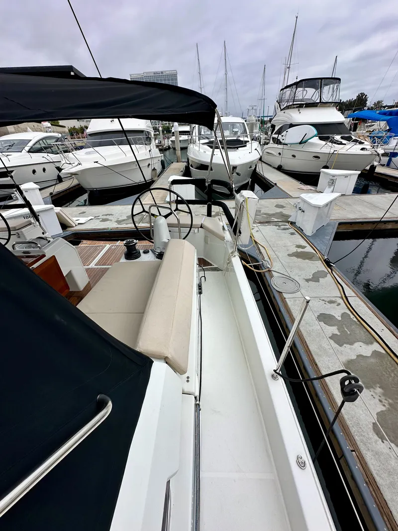 Slide: The Image of 2020 Jeanneau Sun Odyssey 490 sailboat docked in marina, featuring spacious deck and modern design. - 46