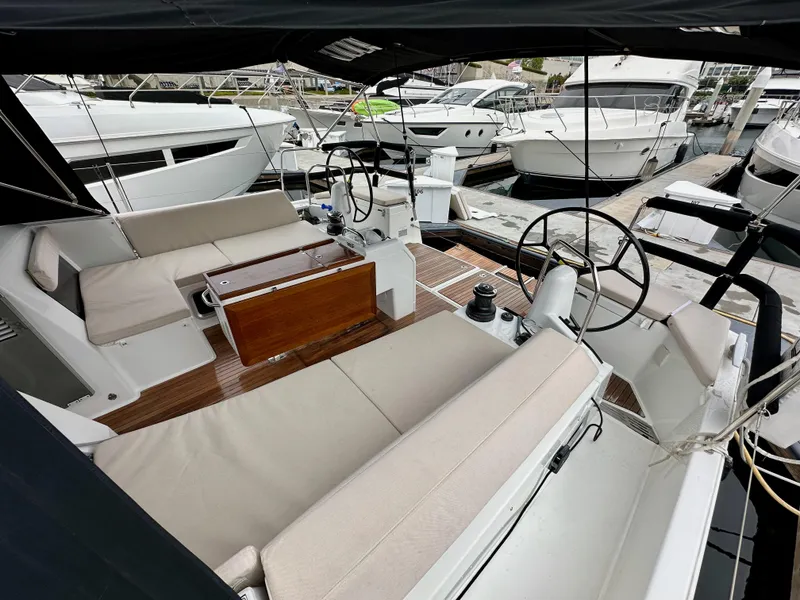 Slide: The Image of 2020 Jeanneau Sun Odyssey 490 yacht interior with dual steering wheels and comfortable seating. - 47