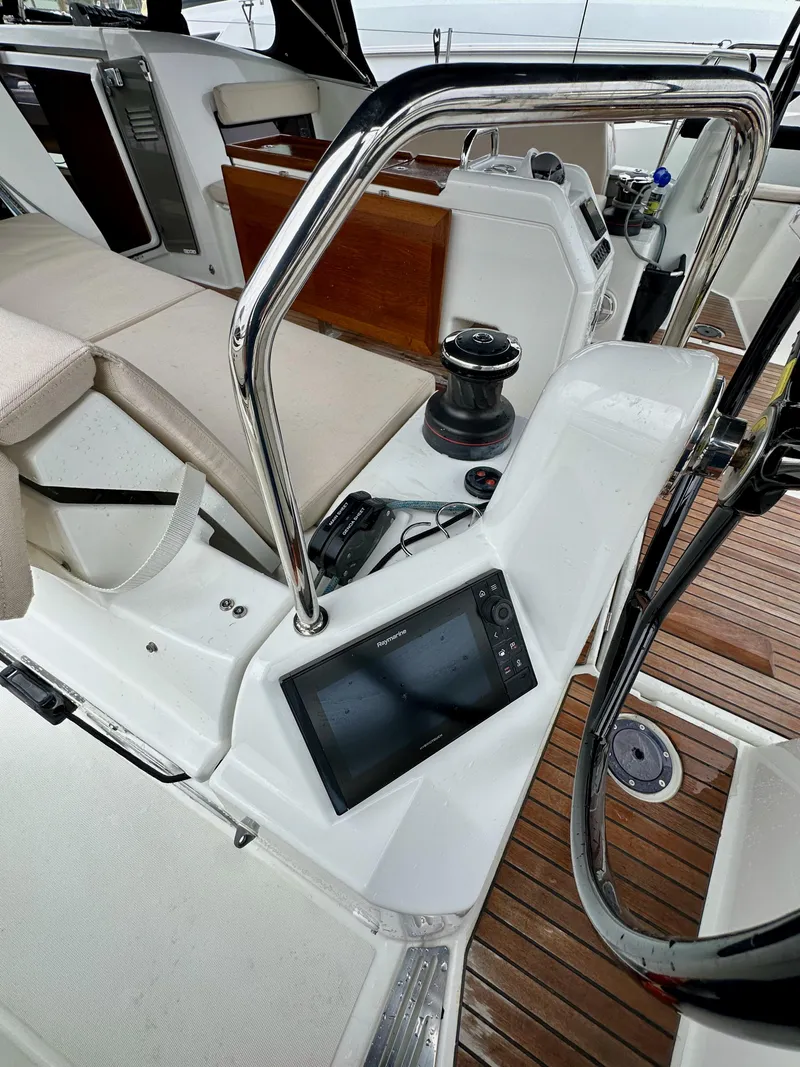 Slide: The Image of Cockpit of 2020 Jeanneau Sun Odyssey 490 with navigation equipment and seating. - 48