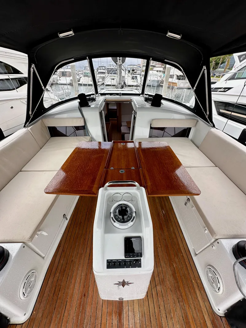 Slide: The Image of 2020 Jeanneau Sun Odyssey 490 yacht interior with wooden table and seating. - 49