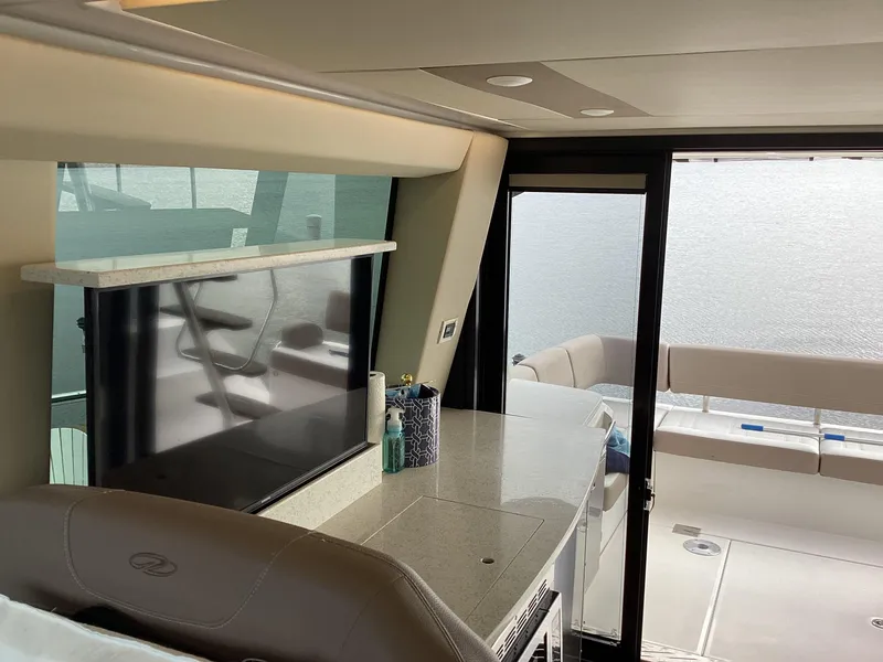 Slide: The Image of Interior of 2018 Regal 42 Fly yacht with modern seating and large windows. - 12